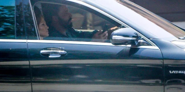 Ben Affleck and Jennifer Lopez took her kids Emme and Max to visit a house in Santa Monica on Friday. Lopez looked busy on the phone while Ben drove the car while house hunting.